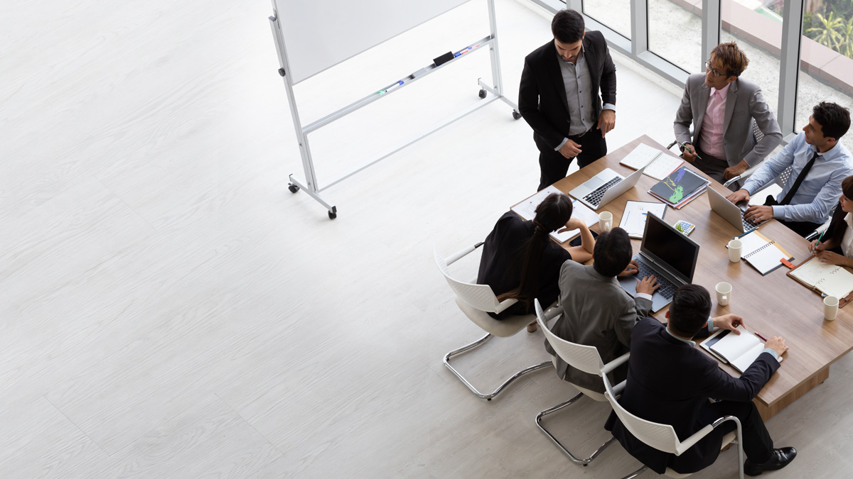 Top view of group of multiethnic busy people working in an office, Aerial view with businessman and businesswoman sitting around a conference table with blank copy space, Business meeting concept